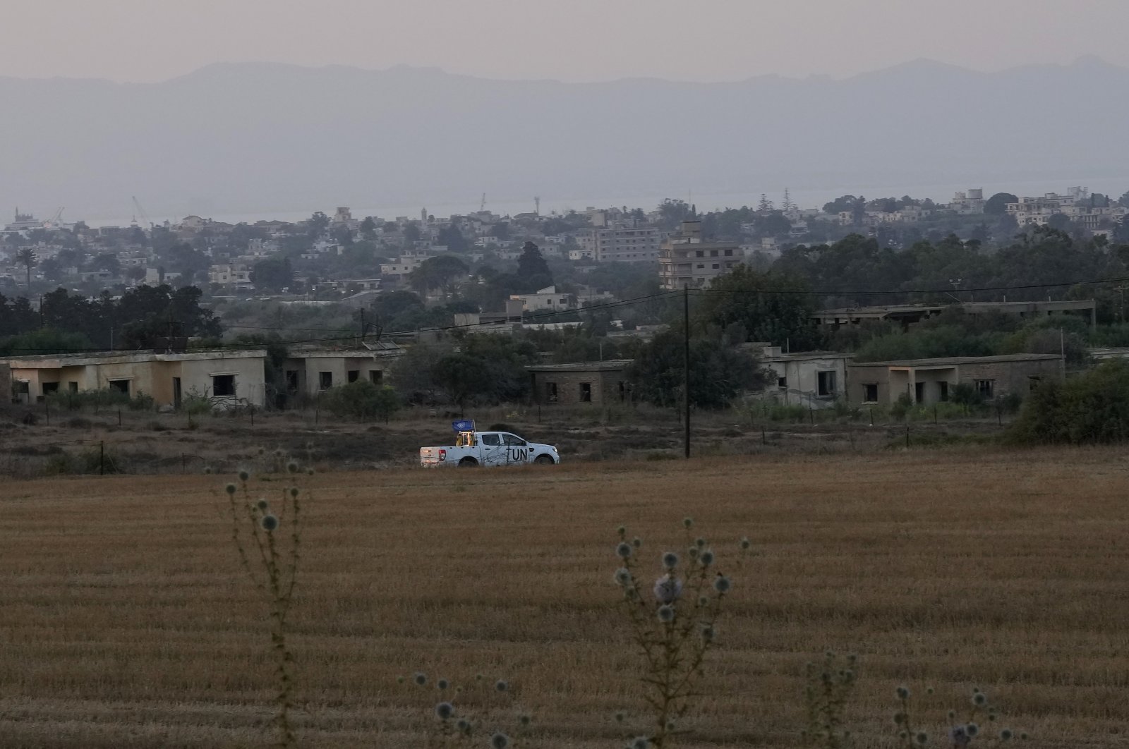 A U.N. vehicle passes the buffer zone next to Varosha, in Dherynia, the island of Cyprus, July 19, 2021. (AP Photo)