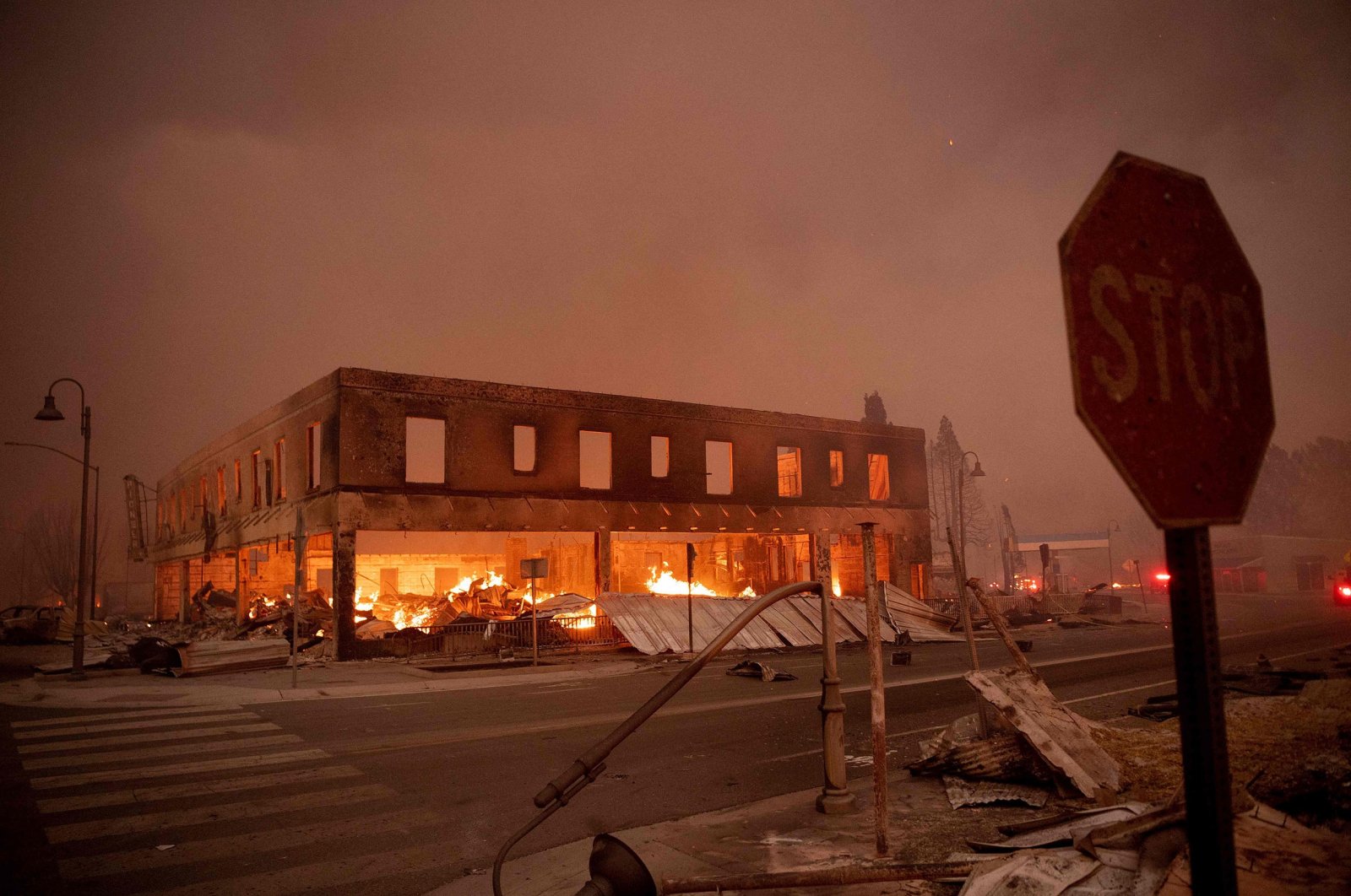 Buildings smolder as the Dixie Fire tears through the Greenville community of Plumas County, California, U.S., Aug. 4, 2021. (AFP Photo)