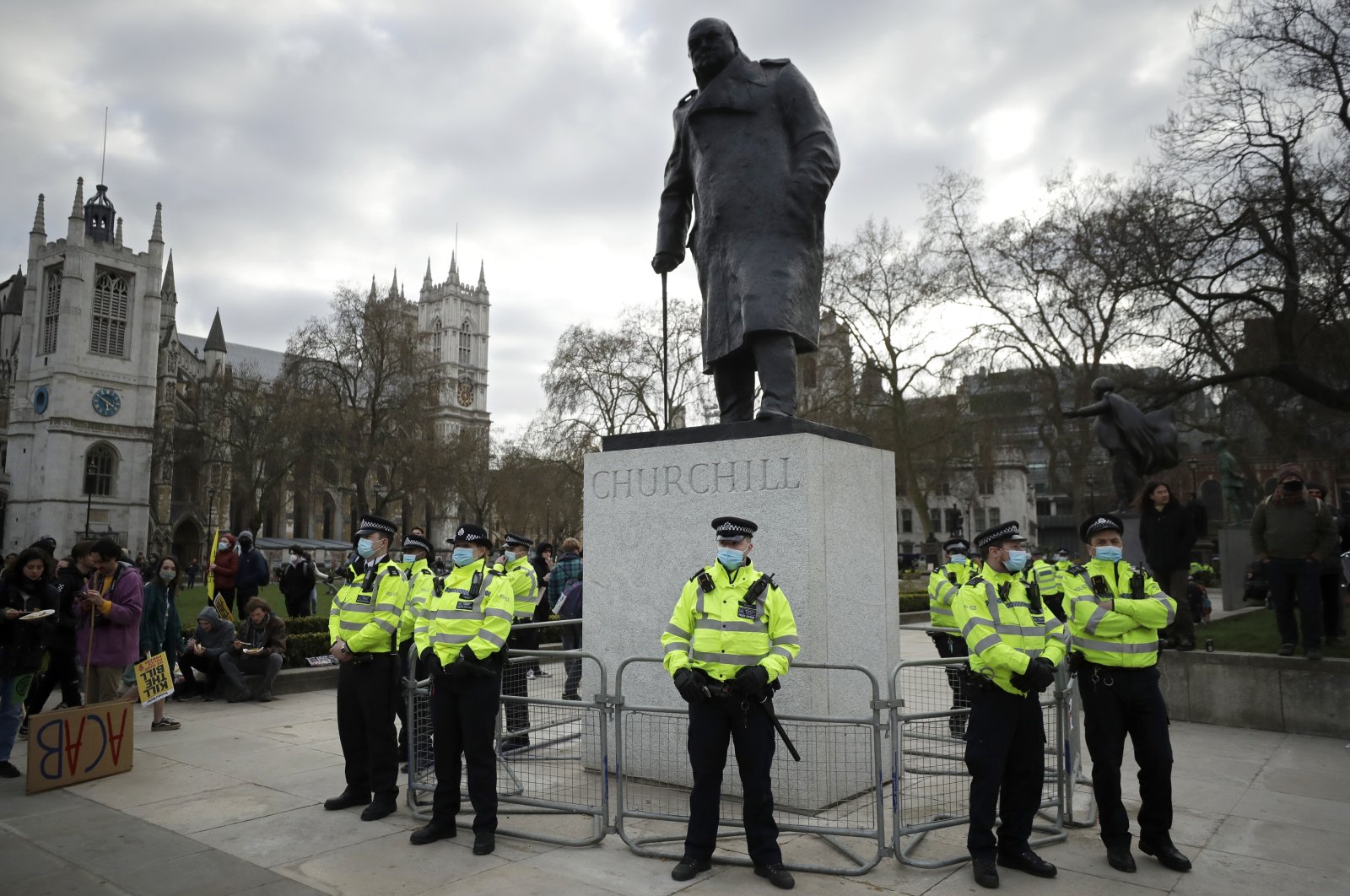 Police stand guard around the statue of wartime prime minister Winston Churchill in Parliament Square during a "Kill the Bill" protest in London, April 3, 2021.  (AP Photo/Matt Dunham)