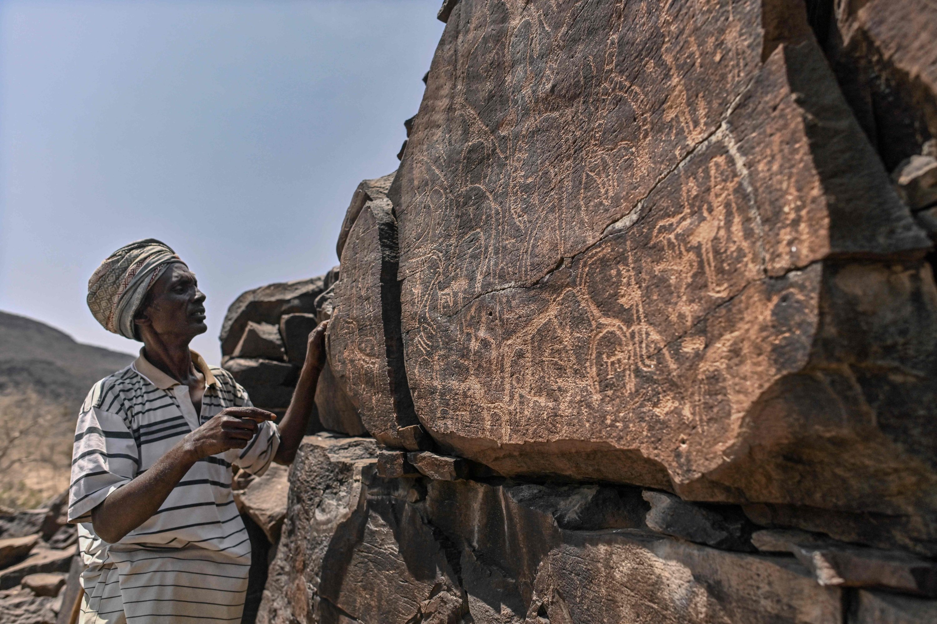 Ibrahim Dabale, 50, an art guardian and native of Djibouti, narrates on ancient depictions at the remote Abourma Rock Art site in the Makarassou Massif of Tadjoura Region, nothern Djibouti, April 13, 2021. (AFP Photo)