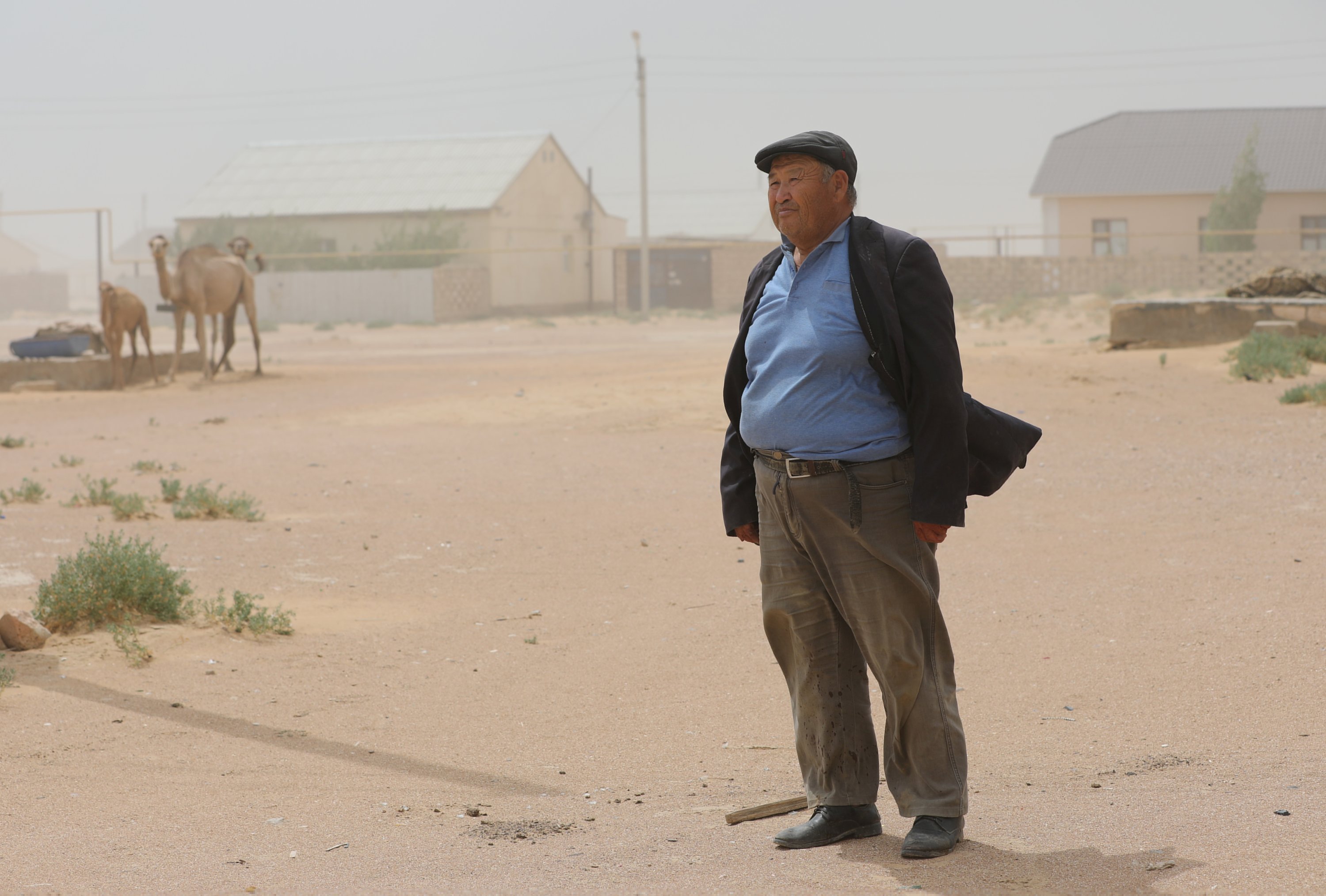 Farmer Gabidolla Kalynbayuly, 70, stands next to his house in the village of Akshymyrau amid severe drought in Mangistau Region, Kazakhstan, on July 27, 2021. (Reuters Photo)