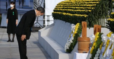 Japan's Prime Minister Yoshihide Suga (L) pays his respects during a ceremony to mark the 76th anniversary of the world's first atomic bomb attack at the Peace Memorial Park in Hiroshima on Aug. 6, 2021. (AFP Photo)