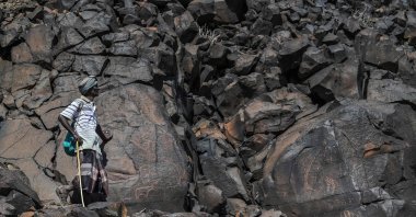 Ibrahim Dabale, 50, an art guardian and native of Djibouti, shows ancient depictions at the remote Abourma Rock Art site in the Makarassou Massif of Tadjoura Region, nothern Djibouti, April 13, 2021. (AFP Photo)