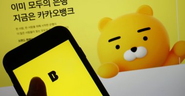 The Kakao Bank app is seen on a mobile phone screen displayed in front of the South Korean digital lender's website in this illustration picture taken Aug. 6, 2021. (Reuters Photo)