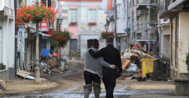 A couple walks on a street in Bad Neuenahr-Ahrweiler, along the Ahr river in Rhineland-Palatinate state, Germany, July 22, 2021. (Reuters Photo)