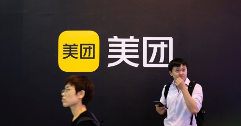 People walk past a Meituan logo at the World Artificial Intelligence Conference (WAIC) in Shanghai, China, July 8, 2021. (Reuters Photo)