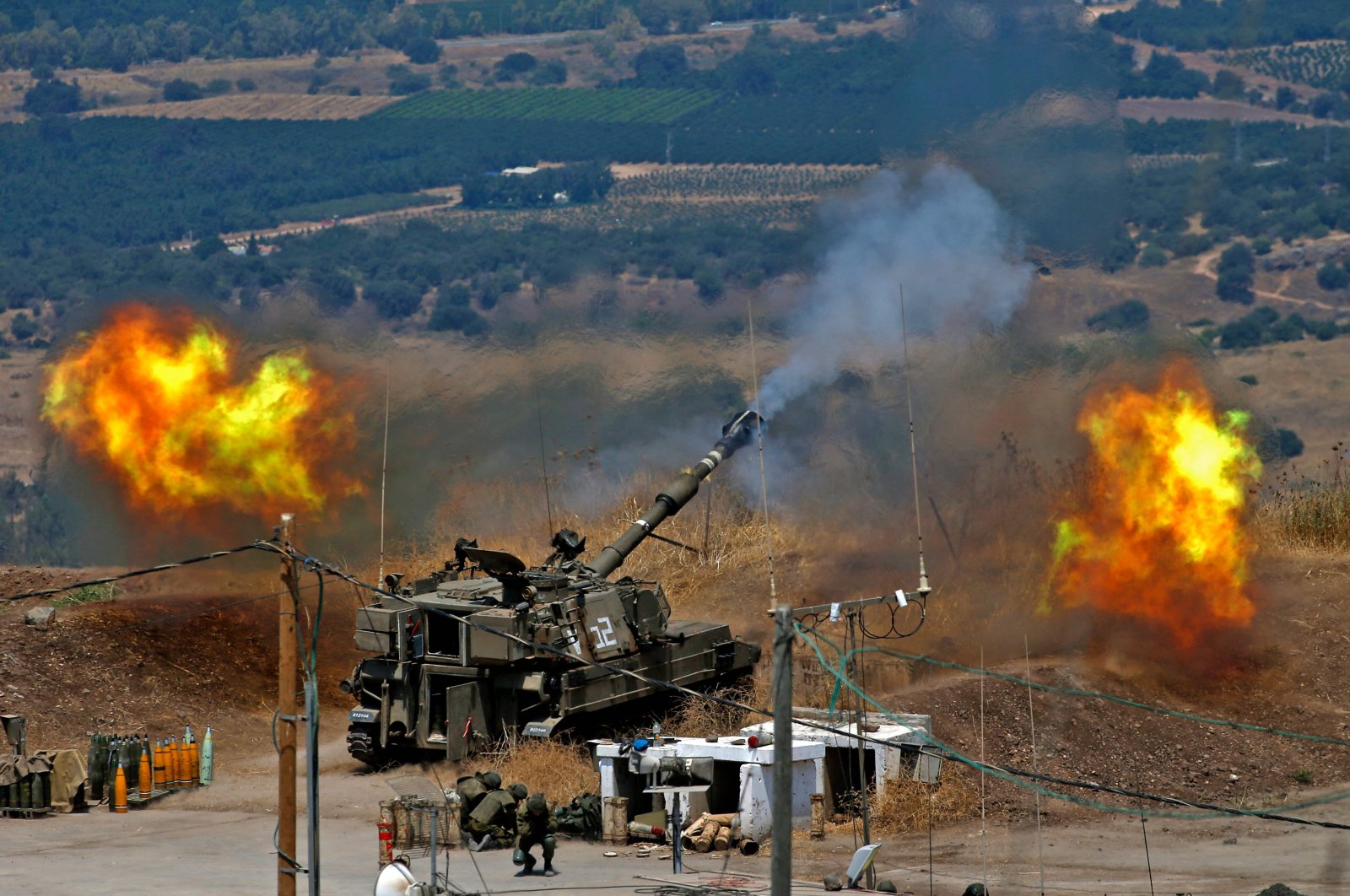 Israeli self-propelled howitzers fire toward Lebanon from a position near Kiryat Shmona, northern Israel, Aug. 6, 2021. (AFP Photo)