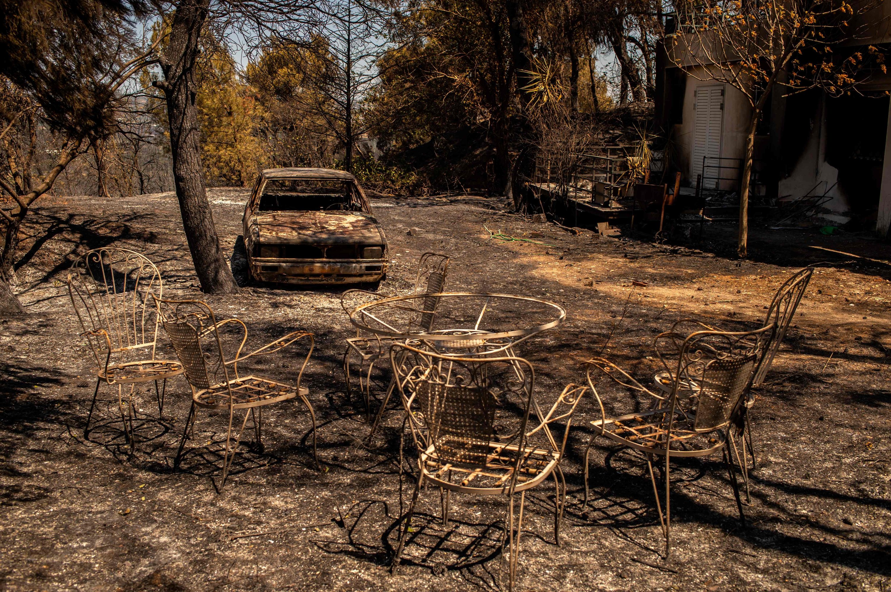 A picture taken in Pefkofito settlement shows a burnt car in a garden, north of Athens, Greece,  Aug. 7, 2021. (AFP Photo)