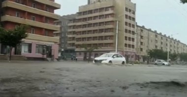 In this image taken from undated North Korean state broadcaster video, vehicles pass through flooded streets after heavy rains across South Hamgyong Province, North Korea. (AP Photo)
