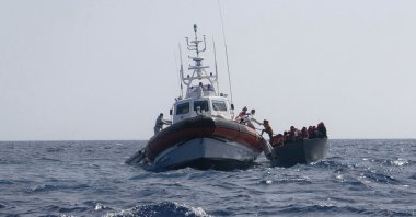 A boat overcrowded with migrants is being rescued by German charity boat Sea-Watch 3 in the Mediterranean sea, Aug. 2, 2021. (Sea-Watch.org via AP)