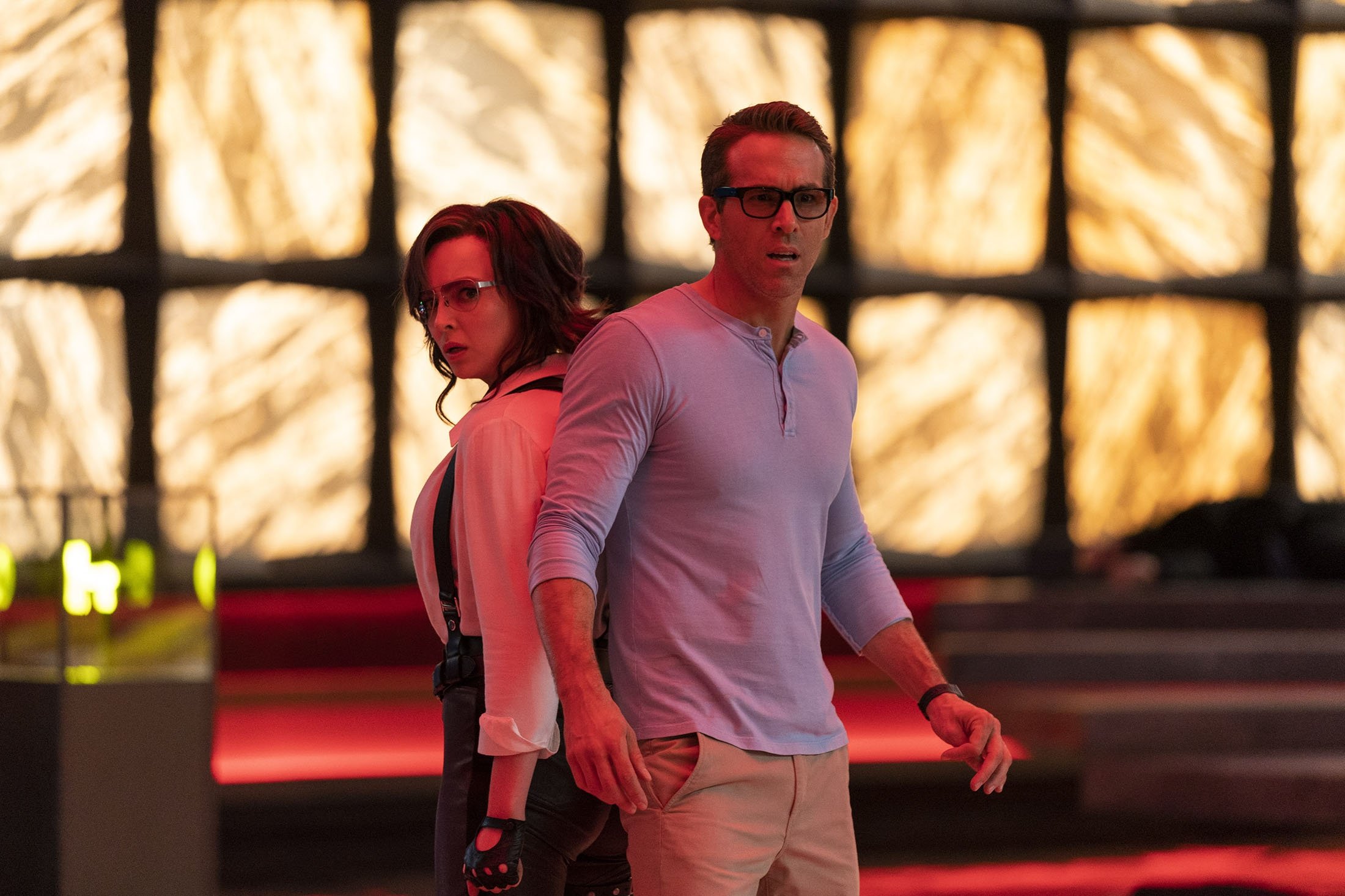 Ryan Reynolds (R) and Jodie Comer stand together in a scene from the film "Free Guy." (20th Century Studios via AP)