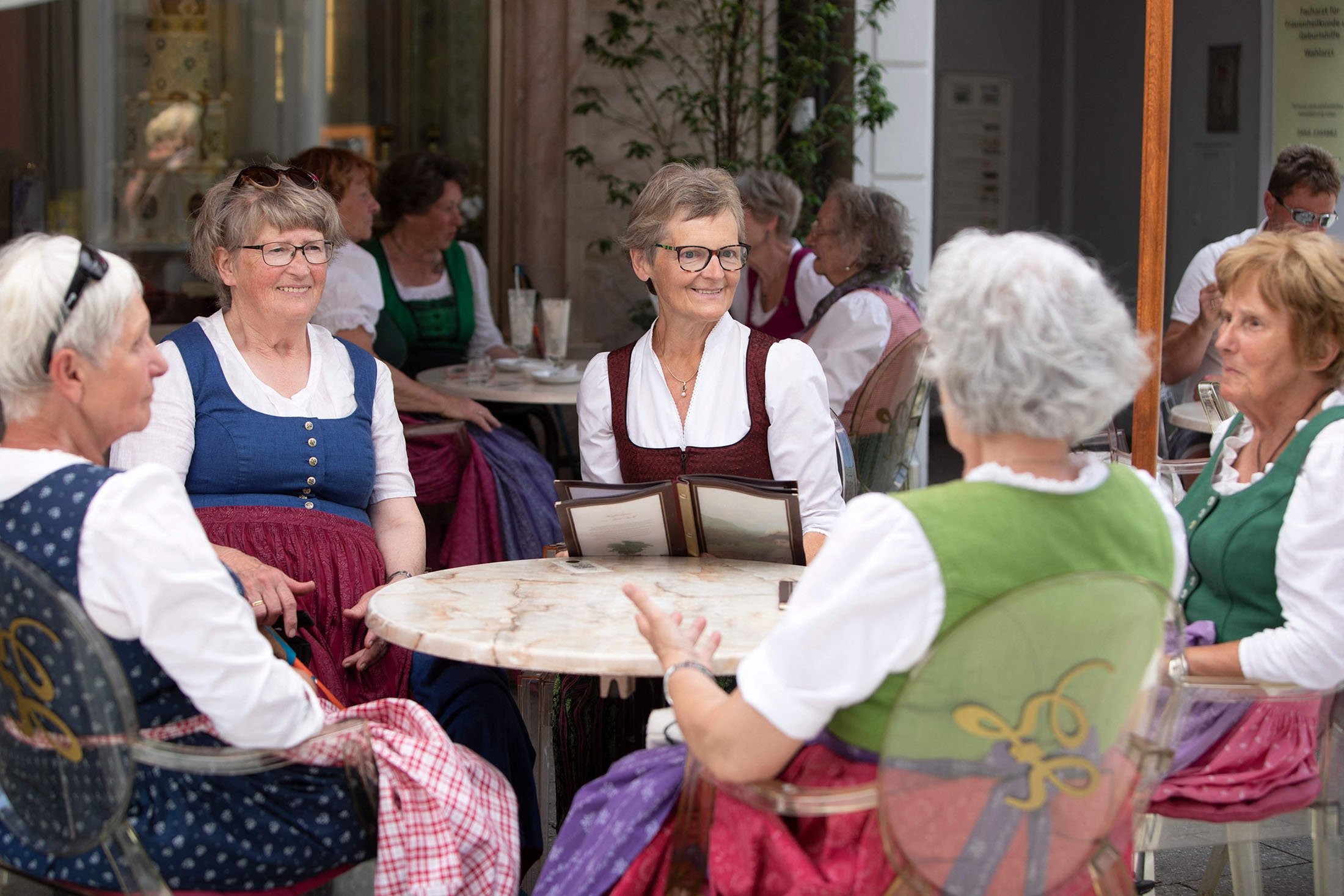 Guests wearing dirndl dreses sit at the Zauner coffee house in Bad Ischl, Upper Austria, June 24, 2021. (AFP Photo)