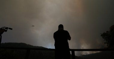 An aircraft operates over a wildfire in Gouves village on the island of Evia, about 185 kilometers (115 miles) north of Athens, Greece, Sunday, Aug. 8, 2021. (AP Photo)