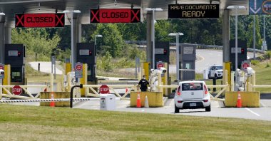 A car approaches one of the few lanes open at the Peace Arch border crossing into the U.S. in Blaine, Wash., June 8, 2021. (AP File Photo)