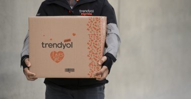 A Trendyol worker holds a package in this undated photo. (Courtesy of Trendyol)
