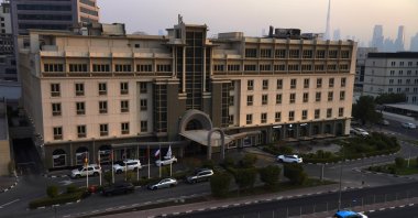The Mövenpick Hotel & Apartments Bur Dubai is seen with the Burj Khalifa, the world's tallest building, behind it in the distance in Dubai, United Arab Emirates, Aug. 6, 2021. (AP Photo)