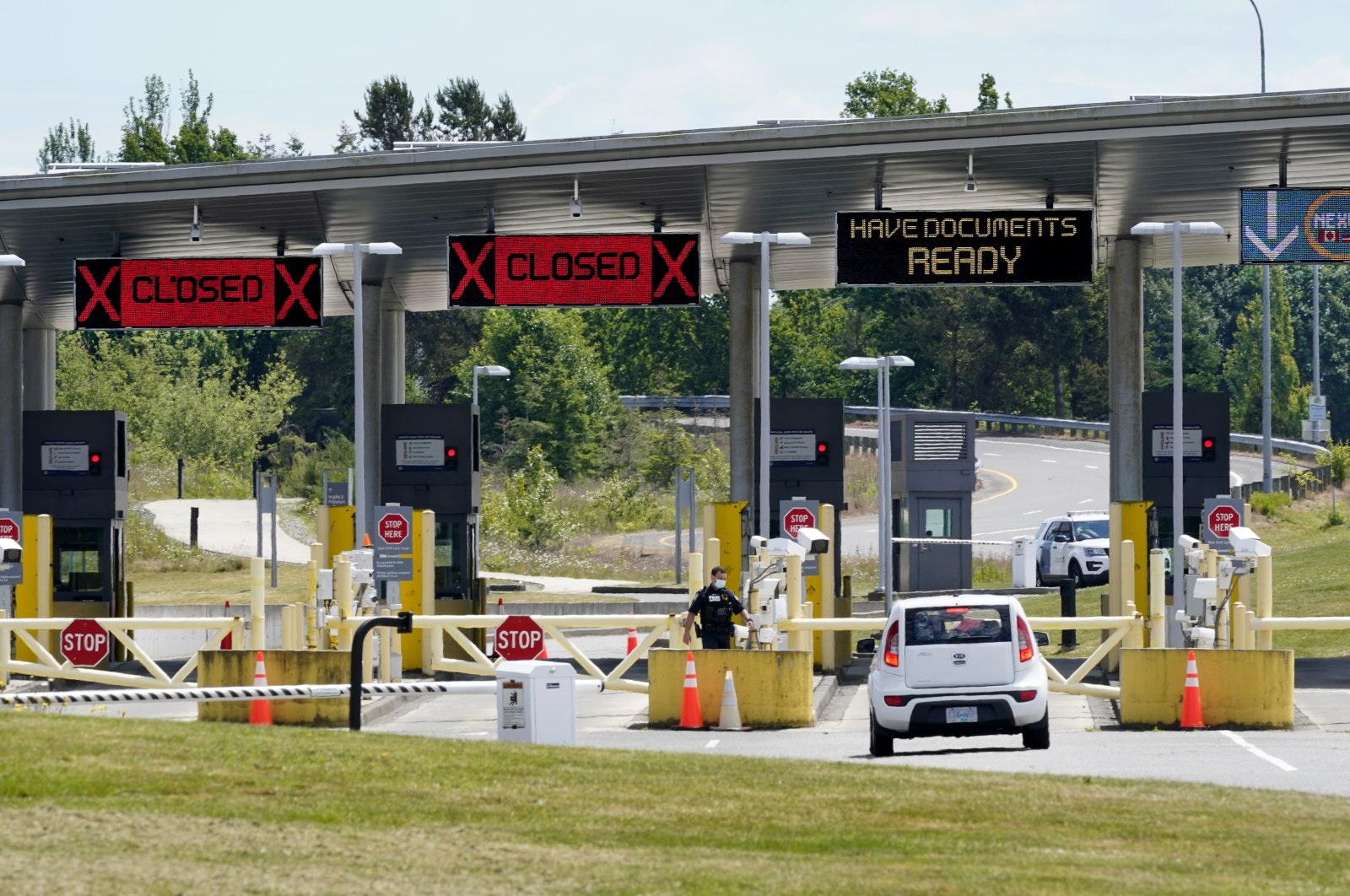 A car approaches one of the few lanes open at the Peace Arch border crossing into the U.S. in Blaine, Wash., June 8, 2021. (AP File Photo)