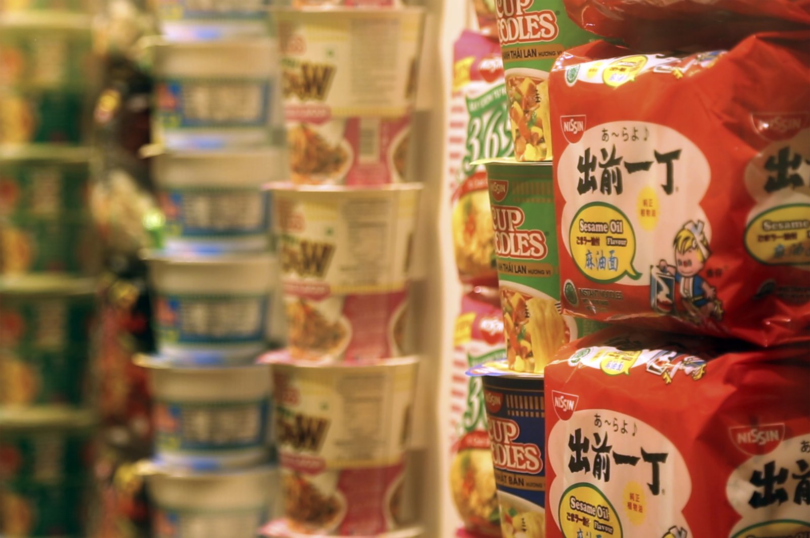 In this frame from video, packets of instant noodles sit on display in the Cup Noodles Museum in Yokohama, Japan, Friday, Aug. 6, 2021. (AP Photo)