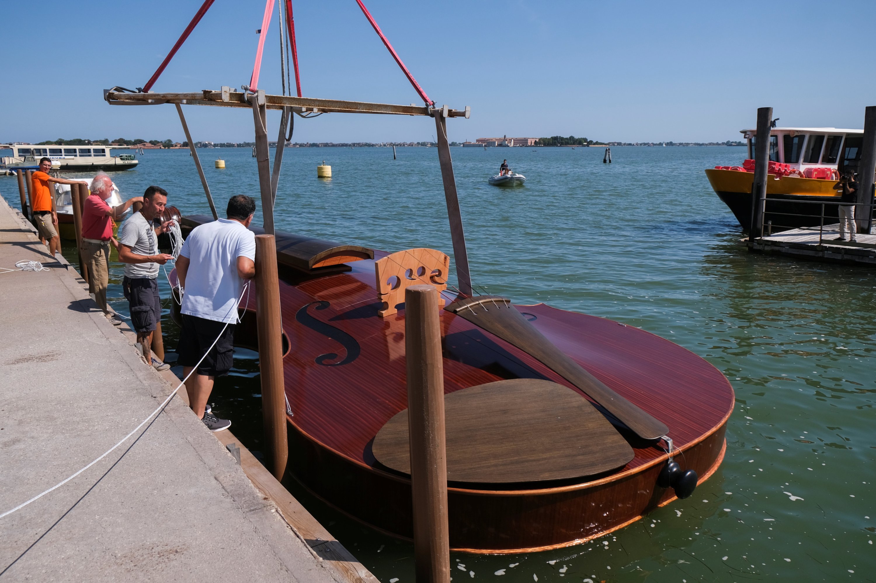 A boat in the shape of a violin, titled 'Violin of Noah', built during the pandemic by artist Livio De Marchi in collaboration with Consorzio Venezia Sviluppo and is dedicated to people who have died from coronavirus, is seen during a test-ride, in Venice, Italy, August 6, 2021. (Reuters Photo)