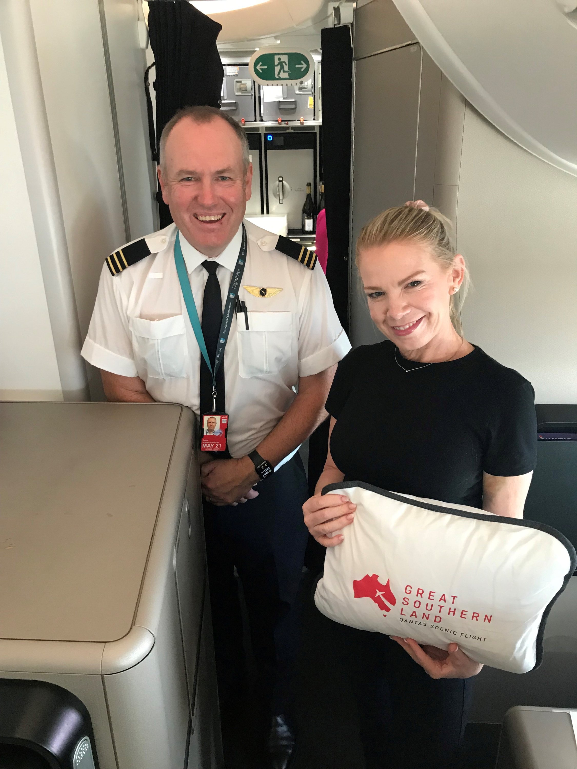 Frequent Flyer Fiona Downes with Qantas Pilot David Summergreene pose for a photo on board the 8-hour Qantas 787 Dreamliner 'Flight to Nowhere' around Australia, Oct. 10, 2020. (Photo by Qantas Airways via Reuters)