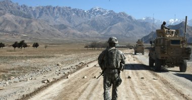 A U.S. soldier from a Provincial Reconstruction Team (PRT) walks along a road under construction near Bagram, about 60 kilometers (about 37 miles) from Kabul, Afghanistan, Jan. 11, 2010. (AFP Photo)