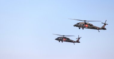 A Sikorsky S-70A-28 and a Blackhawk helicopter belonging to the Gendarmerie General Command are seen in the air during Teknofest, Istanbul, Turkey, on Sept. 18, 2019. (Shutterstock Photo)