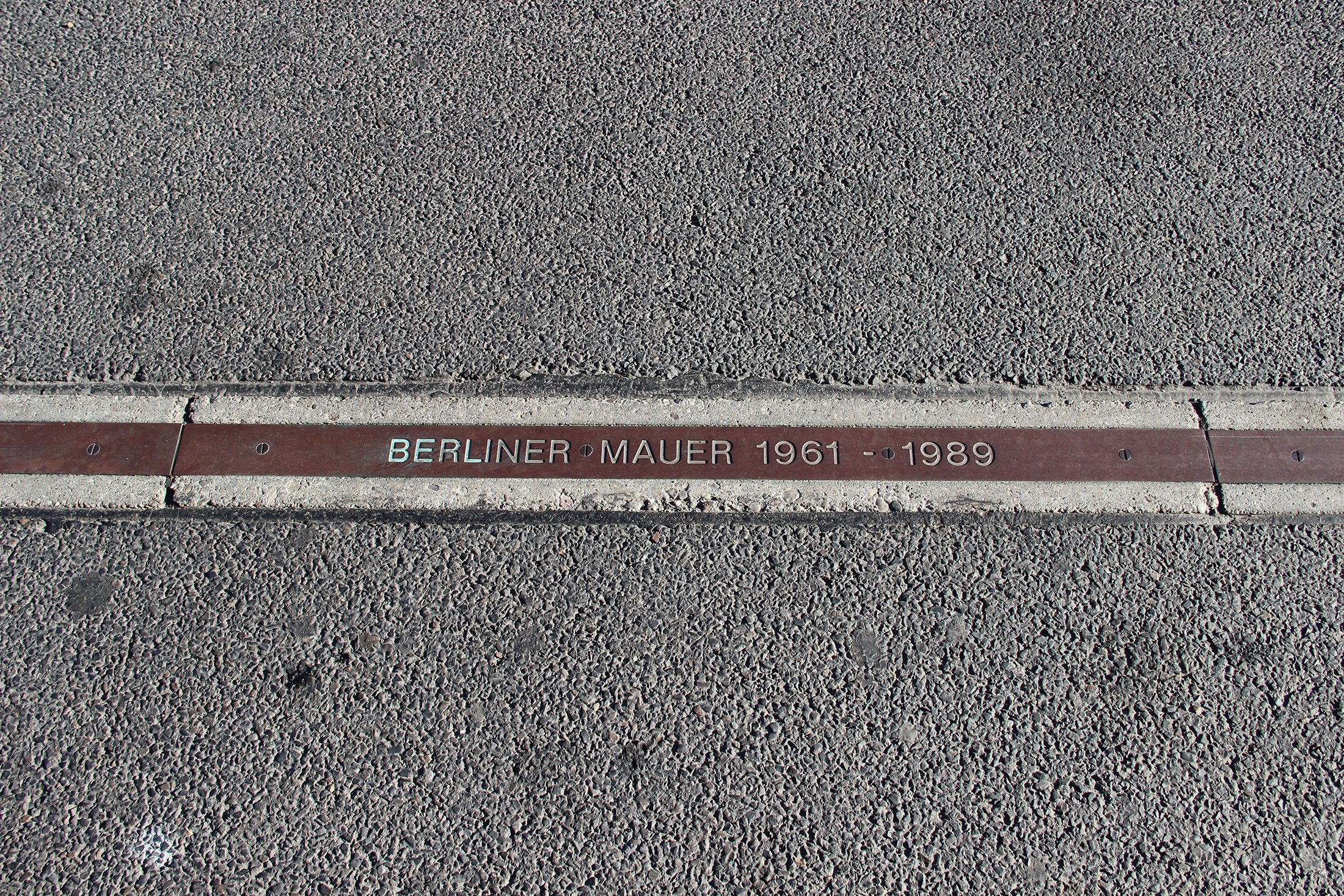 The writing, “Berliner Mauer 1961-1989” (Berlin Wall 1961-1989) marks the remains of the Berlin Wall, Berlin, Germany. (Shutterstock Photo)