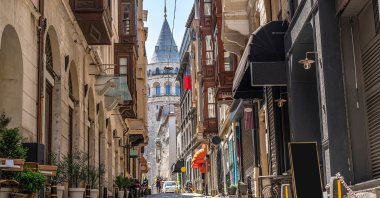 The Galata Tower is seen between historical buildings. (Shutterstock Photo)
