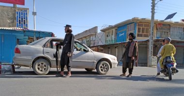 Taliban fighters stand guard at a checkpoint inside the city of Farah, capital of Farah province southwest of Kabul, Afghanistan, Aug. 11, 2021. (AP Photo)