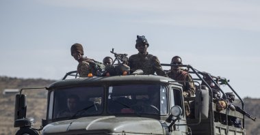 Ethiopian government soldiers ride in the back of a truck on a road near Agula, north of Mekele, in the Tigray region of northern Ethiopia on May 8, 2021. (AP Photo)