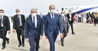 Israeli Foreign Minister Yair Lapid walks with Minister Delegate to the Moroccan Foreign Ministry Mohcine Jazouli, upon his arrival at the airport in Rabat, Morocco August 11, 2021. (Israel Ministry of Foreign Affairs via Reuters)