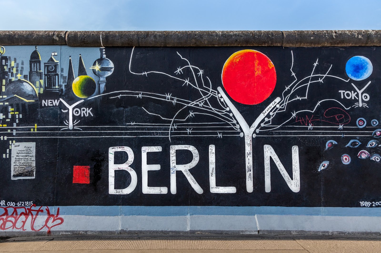 Various graffiti marking different cities can be seen on a part of the original Berlin Wall at East Side Gallery, Berlin, Germany, Sept. 15, 2014. (Shutterstock Photo)