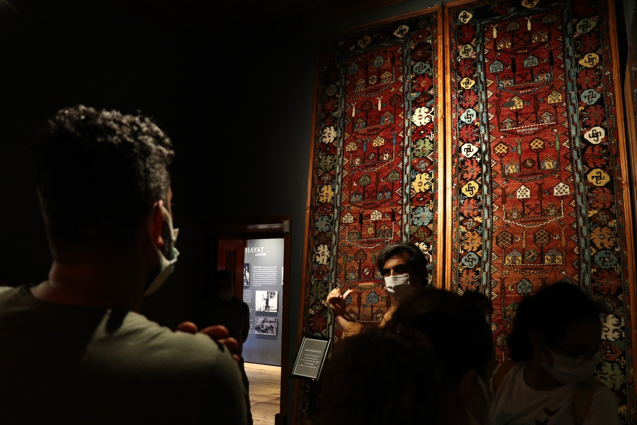 Visitors inspect a historical 100-year-old carpet as it is displayed in the Sille Museum in the Sille district of Konya, Turkey, Aug. 11, 2021. (AA Photo)