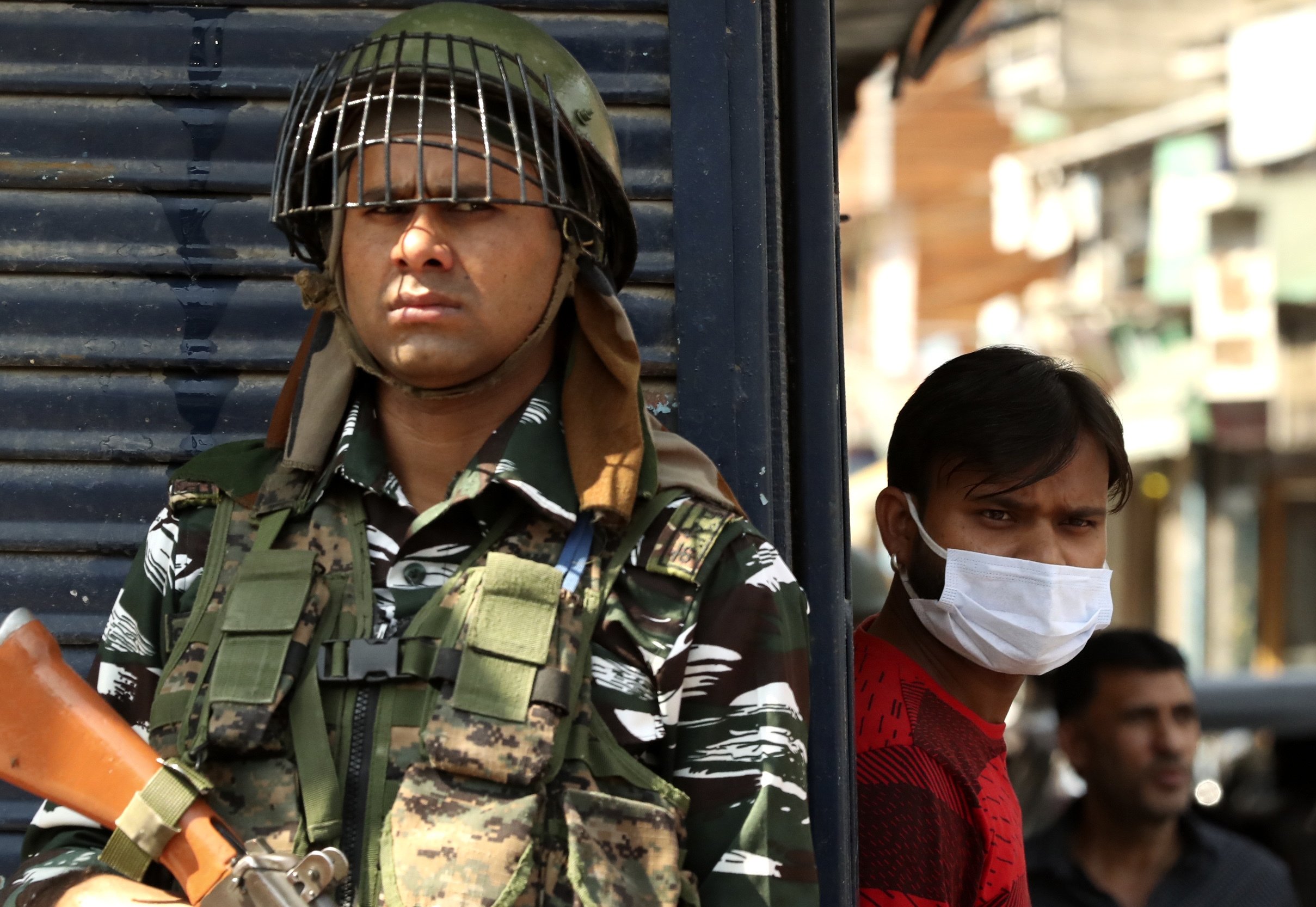 An Indian paramilitary soldier keeps guard near the site of a grenade attack at a busy market in Srinagar, Indian controlled Kashmir, Tuesday, Aug. 10, 2021. (AP Photo)