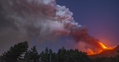 Smoke billows from the Mount Etna volcano as seen from Linguaglossa, Sicily, Aug. 9, 2021. (AP Photo)
