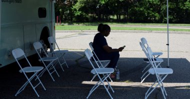 A nurse sits in the waiting area as she and other nurses wait for people to arrive for their COVID-19 vaccinations at a mobile pop-up vaccination clinic in Detroit, Michigan, U.S., July 26, 2021. (Reuters Photo)