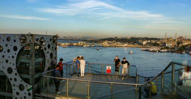 People spend time on Galata Bridge in Eminönü, Istanbul, Turkey, June 26, 2021. (Photo by Shutterstock)