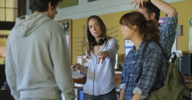 Director Sian Heder (C) talks with actors Emilia Jones (R), and Ferdia Walsh-Peelo, on the set of the film “CODA.” (Apple TV+ via AP)