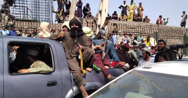 Taliban fighters sit on a vehicle along the street in Jalalabad province, Afghanistan, on Aug. 15, 2021. (AFP Photo)