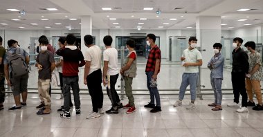 Illegal Afghan migrants wait in line to be sent home at Istanbul Airport, Istanbul, Turkey, Aug. 14, 2021. (AA Photo)
