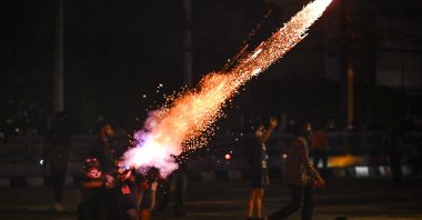 Protesters set off fireworks as they take part in a demonstration in Bangkok on Aug. 15, 2021, calling for the resignation of Thailand's Prime Minister Prayut Chan-Ocha over the government's handling of the COVID-19 crisis. (AFP Photo)