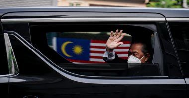 Malaysia's Prime Minister Muhyiddin Yassin waves as he arrives at the National Palace in Kuala Lumpur, Malaysia, on Aug. 16, 2021, as he was expected to quit after just 17 months in office. (AA Photo)