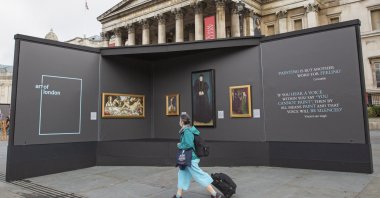 A member of the public visits an outdoor gallery in Trafalgar Square, London, as part of the Inside Out festival. (DPA Photo) 