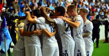 Fenerbahçe players celebrate Mesut Özil's goal in a Turkish Süper Lig match against Adana Demispor at the Yeni Adana Staduim, Adana, southeast Turkey, Aug. 15, 2021. (DHA Photo)