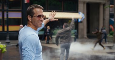 Ryan Reynolds smiles in a scene from the film "Free Guy." (20th Century Studios via AP)