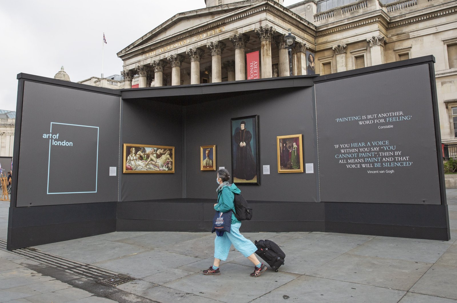 A member of the public visits an outdoor gallery in Trafalgar Square, London, as part of the Inside Out festival. (DPA Photo) 