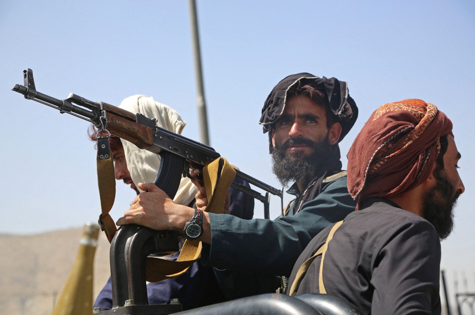 Taliban fighters stand guard in a vehicle along the roadside after a stunningly swift end to Afghanistan's 20-year war, as thousands of people mobbed the city's airport trying to flee the group's feared hardline brand of rule, Kabul, Afghanistan, Aug. 16, 2021. (AFP Photo)