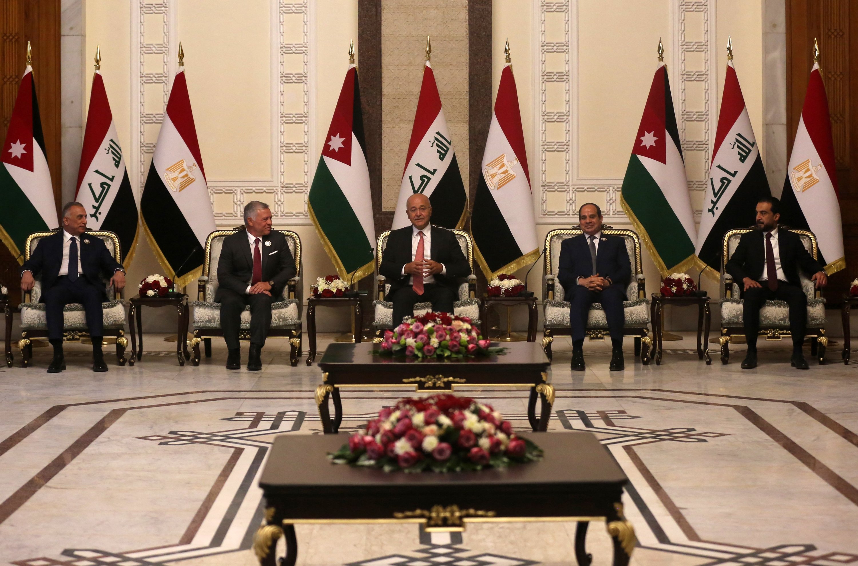 Iraqi President Barham Saleh (C), Prime Minister Mustafa al-Kadhimi (L) and Parliament Speaker Muhammad al-Halbousi (R) receive Egypt's President Abdel-Fattah el-Sissi (C-R), and Jordan's King Abdullah II (C-L), in the capital Baghdad, Iraq, June 27, 2021. (AFP Photo)