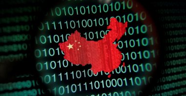 A map of China is seen through a magnifying glass on a computer screen showing binary digits in Singapore in this Jan. 2, 2014 photo illustration. (Reuters Photo)