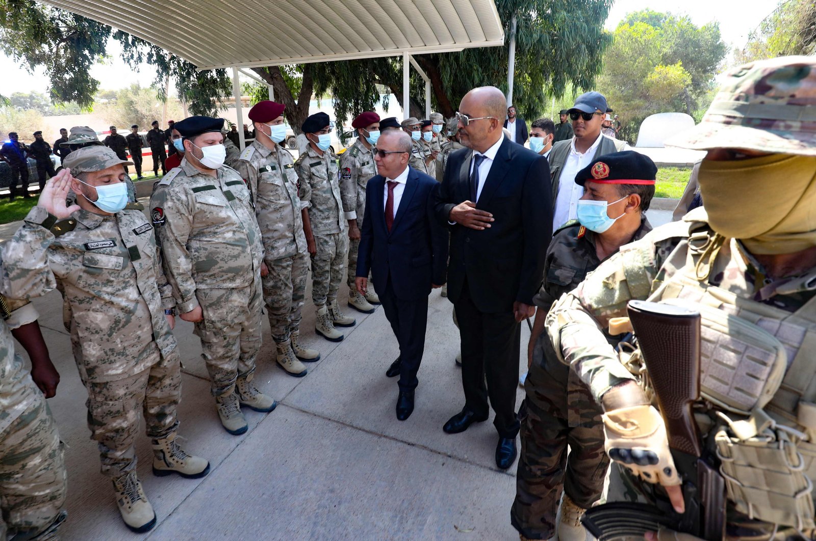 Members of Libya's Presidential Council, Moussa Al-Koni (R) and Abdullah Al-Lafi, visit a camp for Libyan special forces trained by the Turkish military, in the coastal city al-Khums, about 120kms east of the capital Tripoli, on August 15, 2021. (Photo by Mahmud TURKIA / AFP)